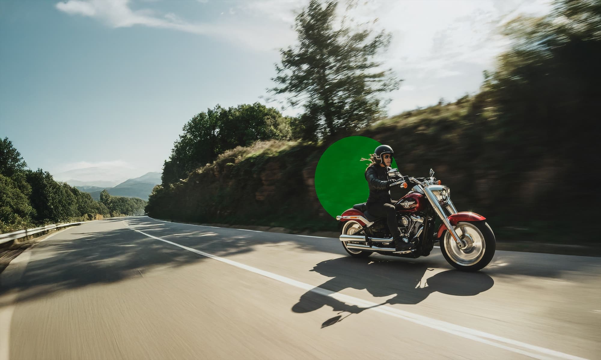 Person speeding on a motorcycle on a winding road