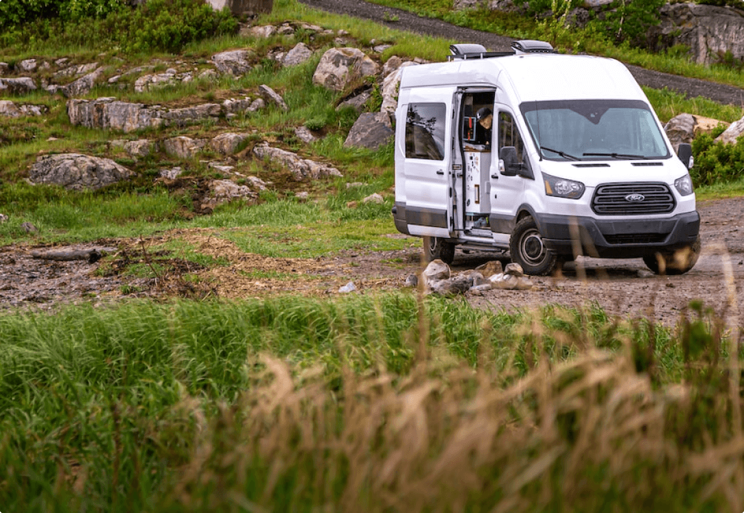 White Ford Transit van in rocky terrain